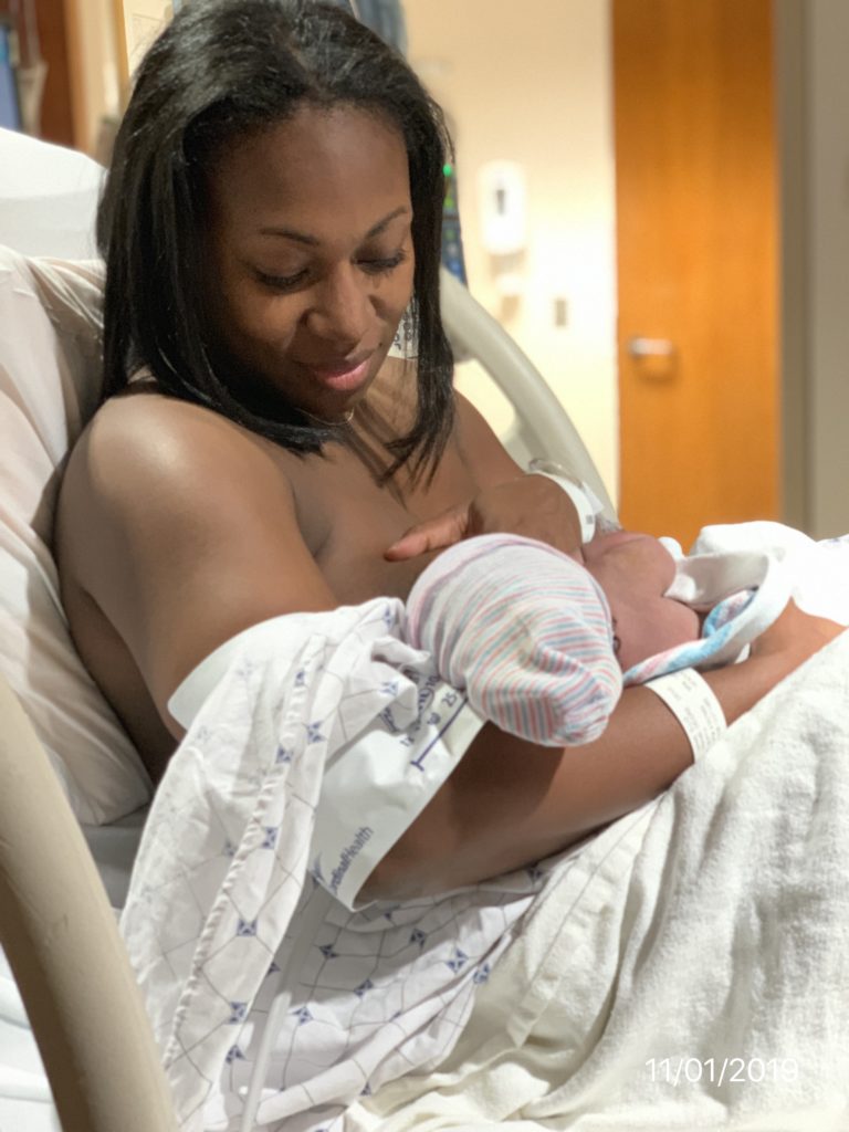 mom holding newborn moments after natural birth in hospital