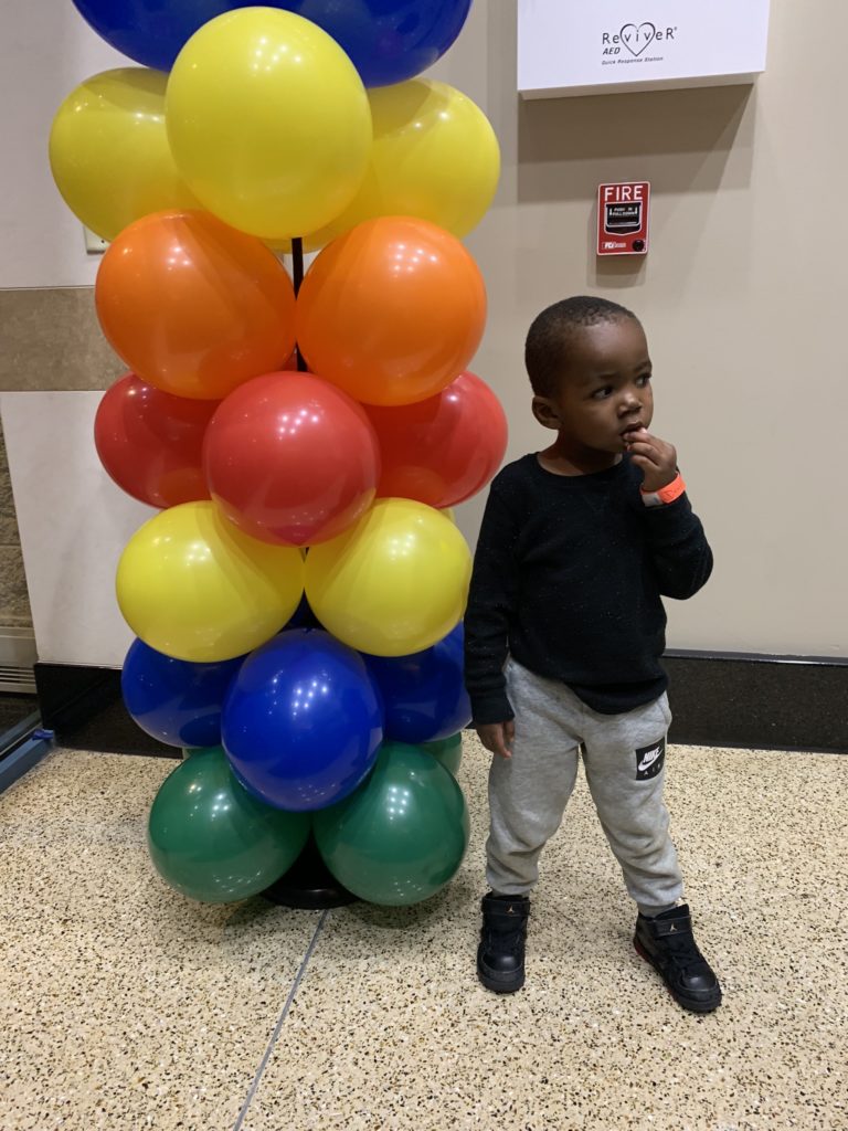 Little boy with balloons about to become a big brother after mom gives birth 